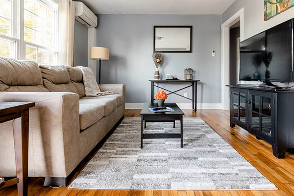 living room with a black leather couch and coffee table in the middle of the room